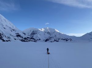 Photo of field team member traversing the lower Kahiltna Glacier to Camp 1