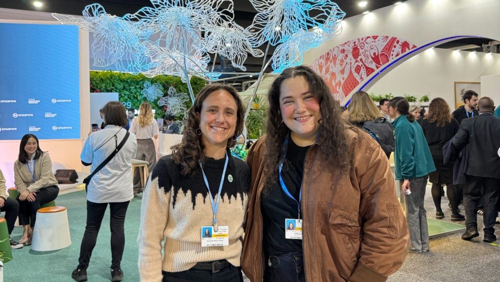 A photo of Professor Danielle Falzon and Holly Fain standing in the Delegation Pavilions