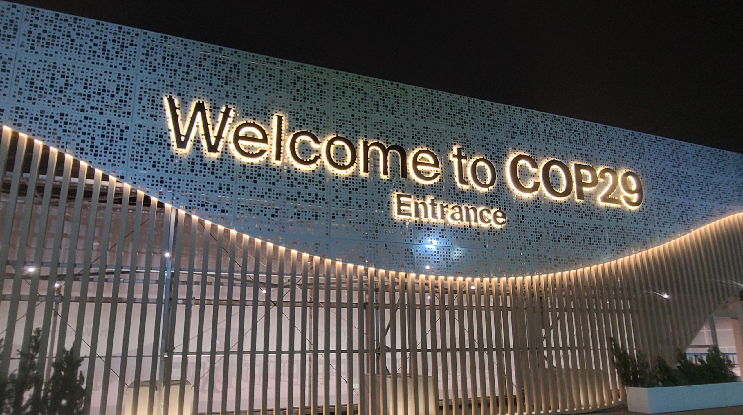 A photo of a sign that says "Welcome to COP29 Entrance"