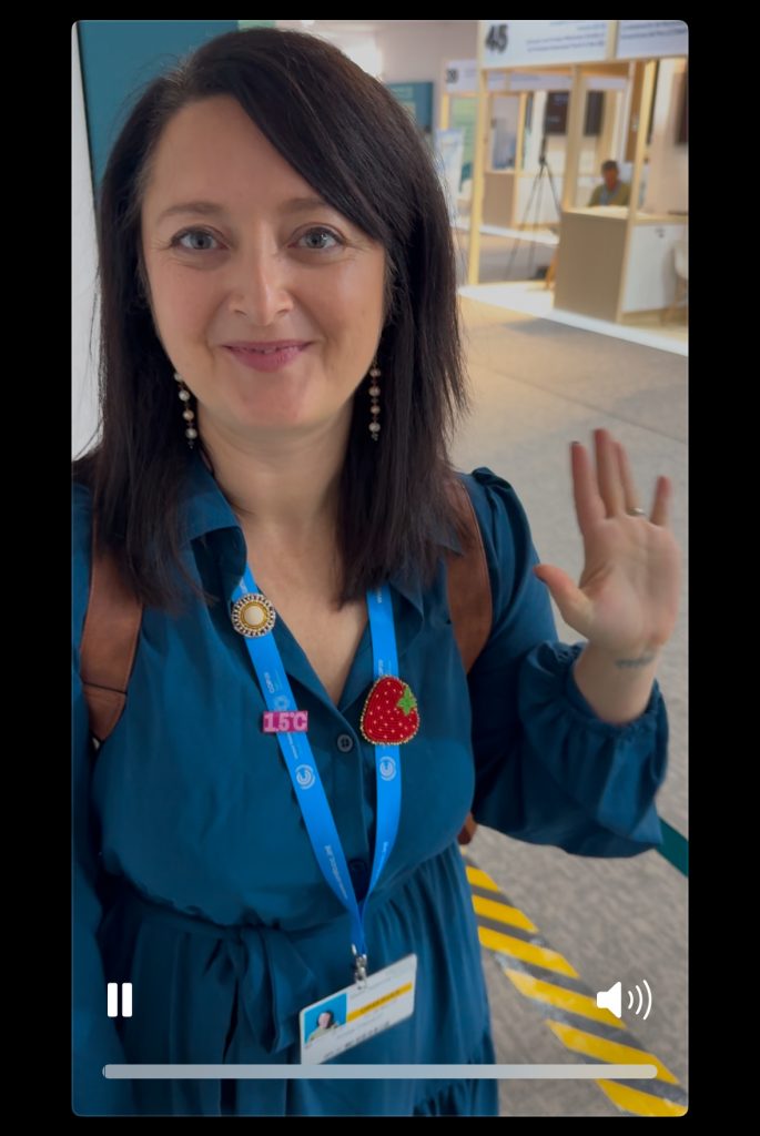 Indigenous Peoples’ Caucus member, Krista Clement, standing outside of the IIPFCC 9:00-10:00 AM Meeting Room.
