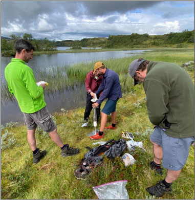 Team field members slicing a sediment core.