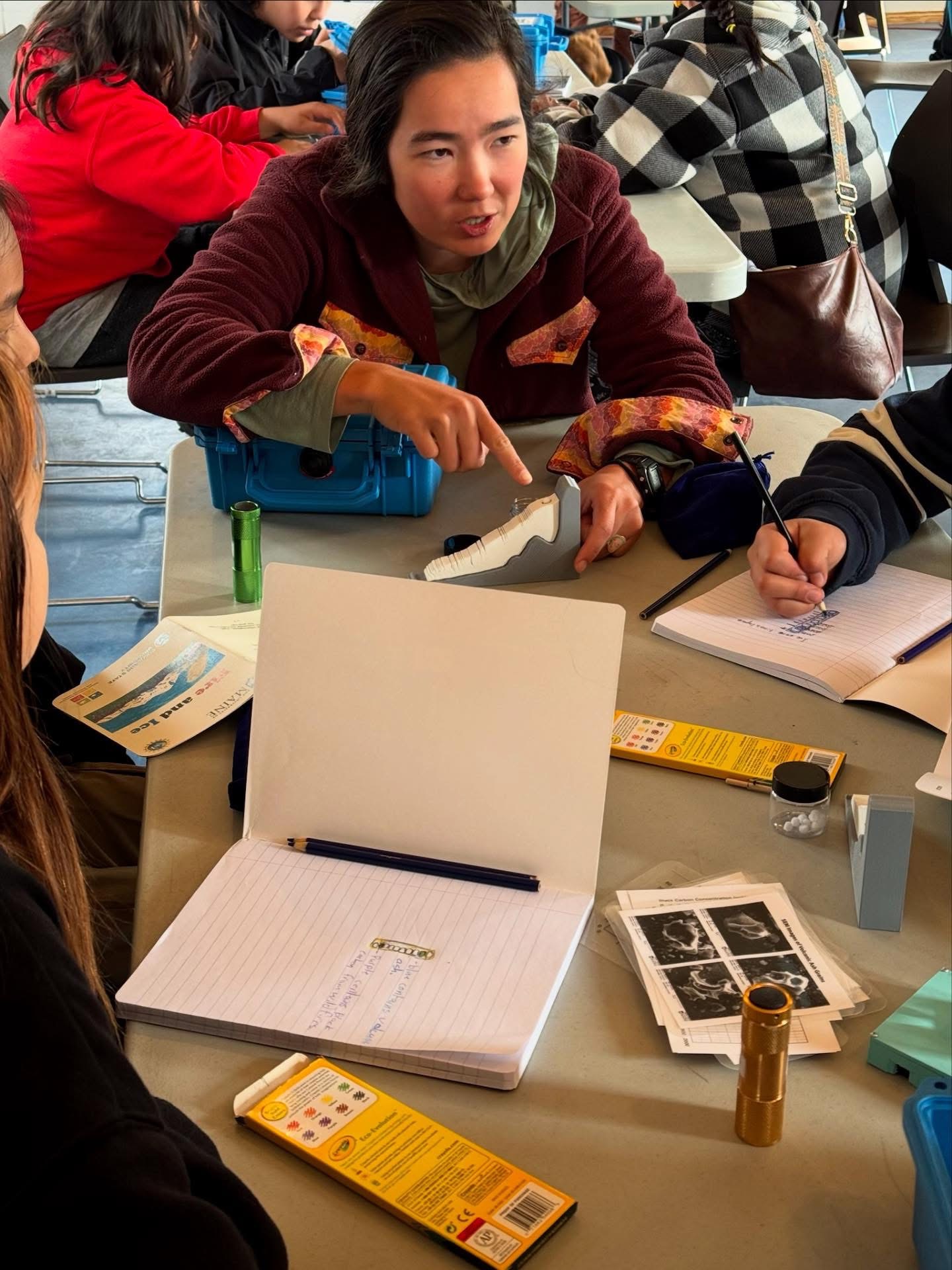 Photo of Inga Kindstedt and group discussing snow accumulation.